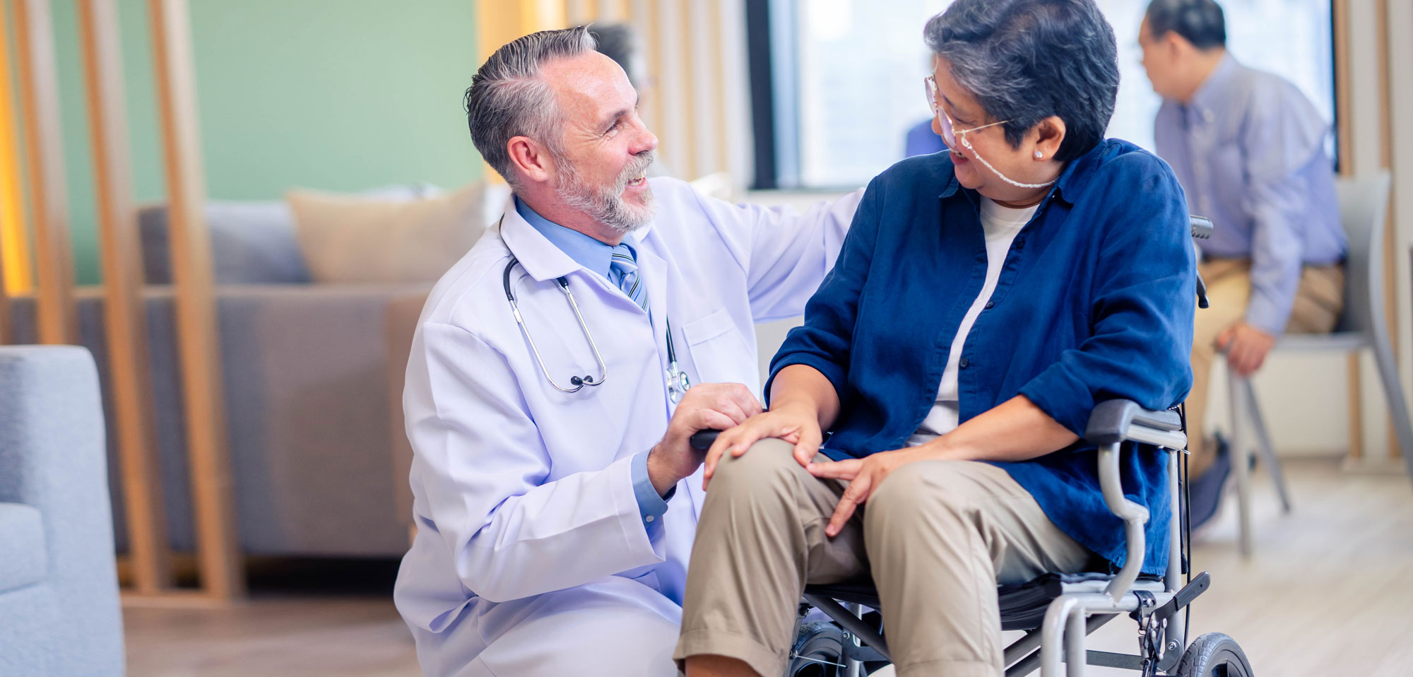 Senior female in a wheelchair with doctor